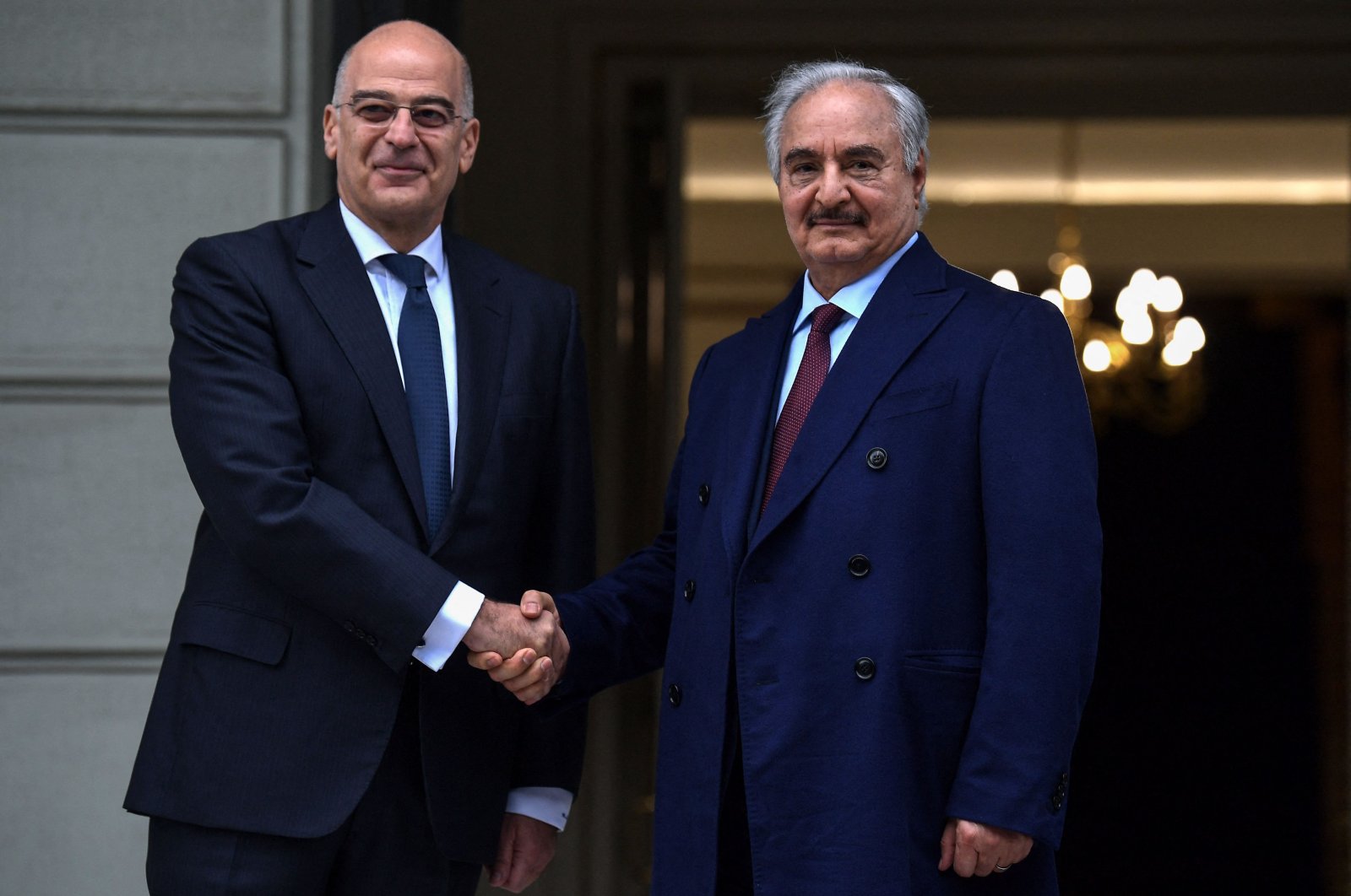  In this file photo taken on Jan. 17, 2020, Greek Foreign Minister Nikos Dendias (L) welcomes putschist Gen. Khalifa Haftar before talks in Athens, days ahead of a peace conference in Berlin. (AFP File Photo)