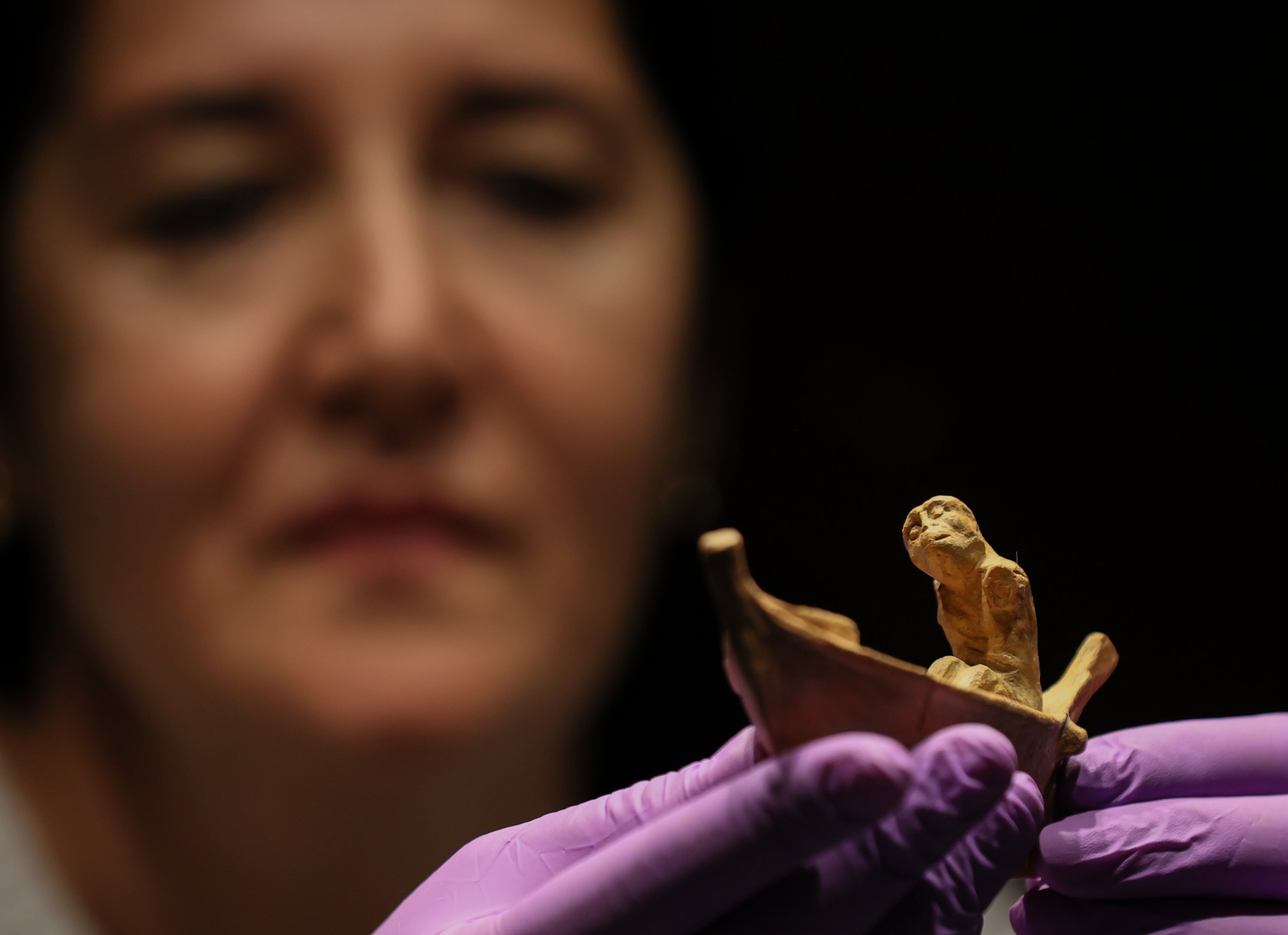 Izmir Archeology Museum assistant manager Elif Erginer shows the 2,400-year-old statuette depicting the ferryman of the dead, Charon, Izmir, Türkiye, Nov. 15, 2022. (AA Photo)