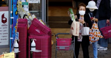 Customers carrying shopping bags are seen outside a supermarket in Tokyo, Japan, Oct., 21, 2022. (Reuters Photo)