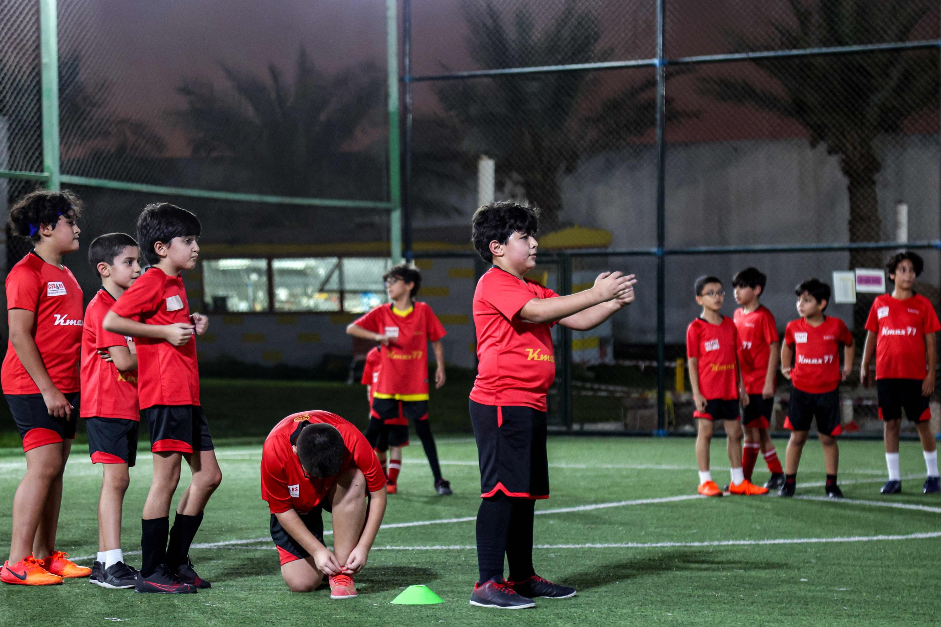 Children train on a football pitch at the Cedars Sports Academy in Qatar's capital Doha, Nov. 8, 2022. (AFP Photo)