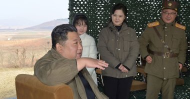 This picture taken on Nov. 18, 2022, and released by North Korea's official Korean Central News Agency (KCNA) on Nov. 19, 2022 shows North Korea's leader Kim Jong Un (Left), with his wife Ri Sol Ju (2nd Right) and his daughter (2nd Left-behind), as they attend the test-firing of the new intercontinental ballistic missile (ICBM) "Hwasong Gun 17" type at an undisclosed location in North Korea. (Photo by KCNA VIA KNS / AFP)