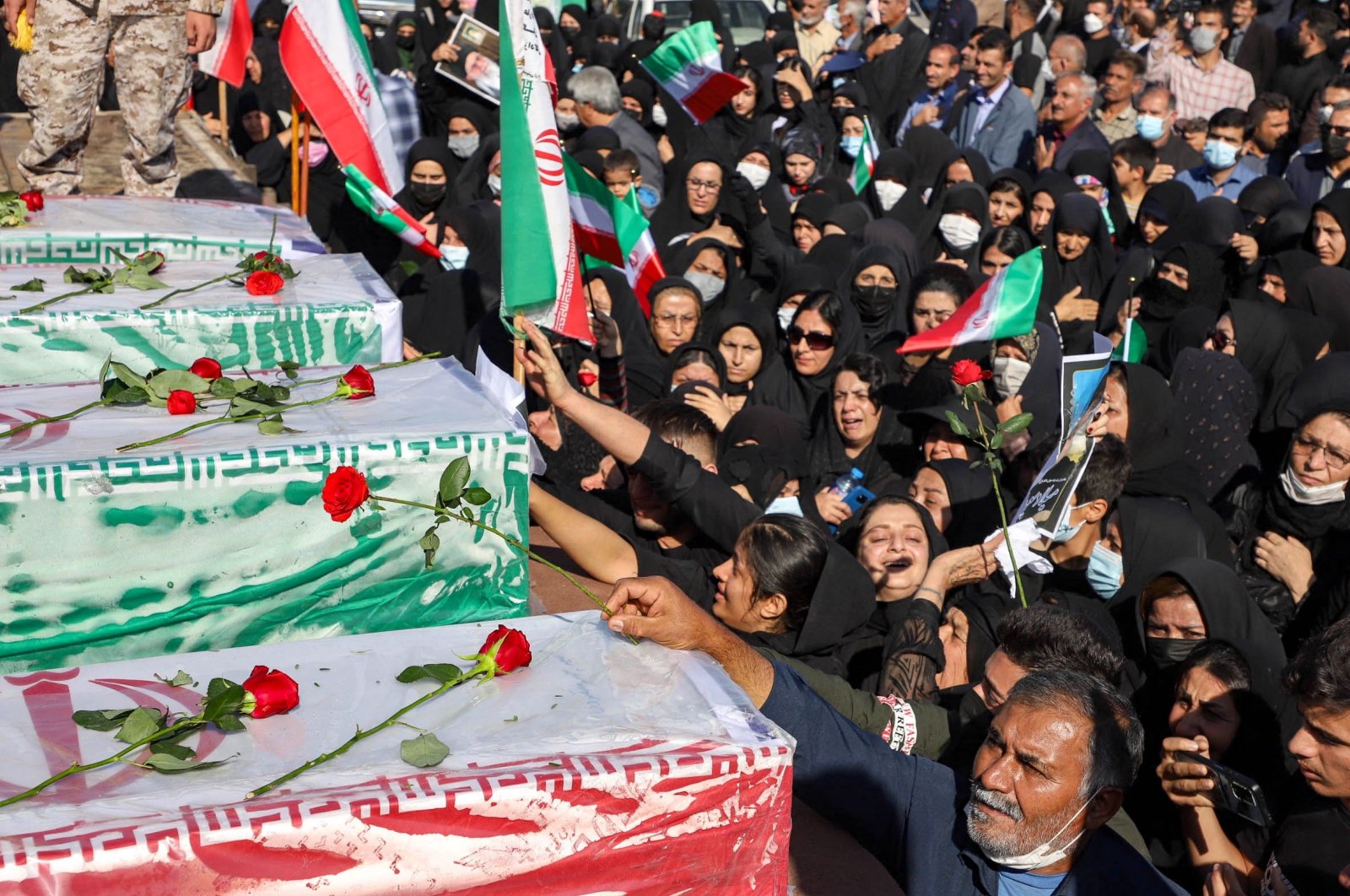 Iranians mourn in front of the coffins of people killed in a shooting attack, during their funeral in the city of Izeh in Iran&#039;s Khuzestan province, on Nov. 18, 2022. In some of the worst violence since the protests erupted, assailants on motorbikes shot dead seven people, including a woman and two children aged 9 and 13, at a central market of Izeh on the evening of Nov. 16, 2022, state media said. (AFP Photo)