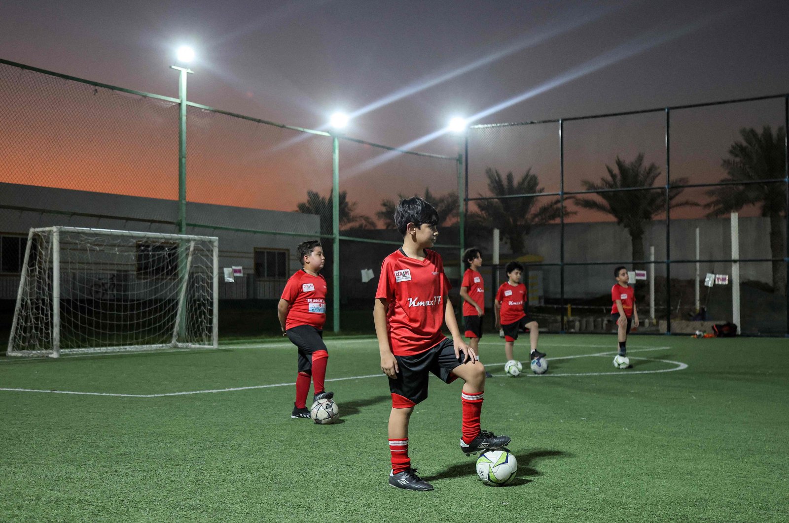 Children train on a football pitch at the Cedars Sports Academy in Qatar&#039;s capital Doha, Nov. 8, 2022. (AFP Photo)