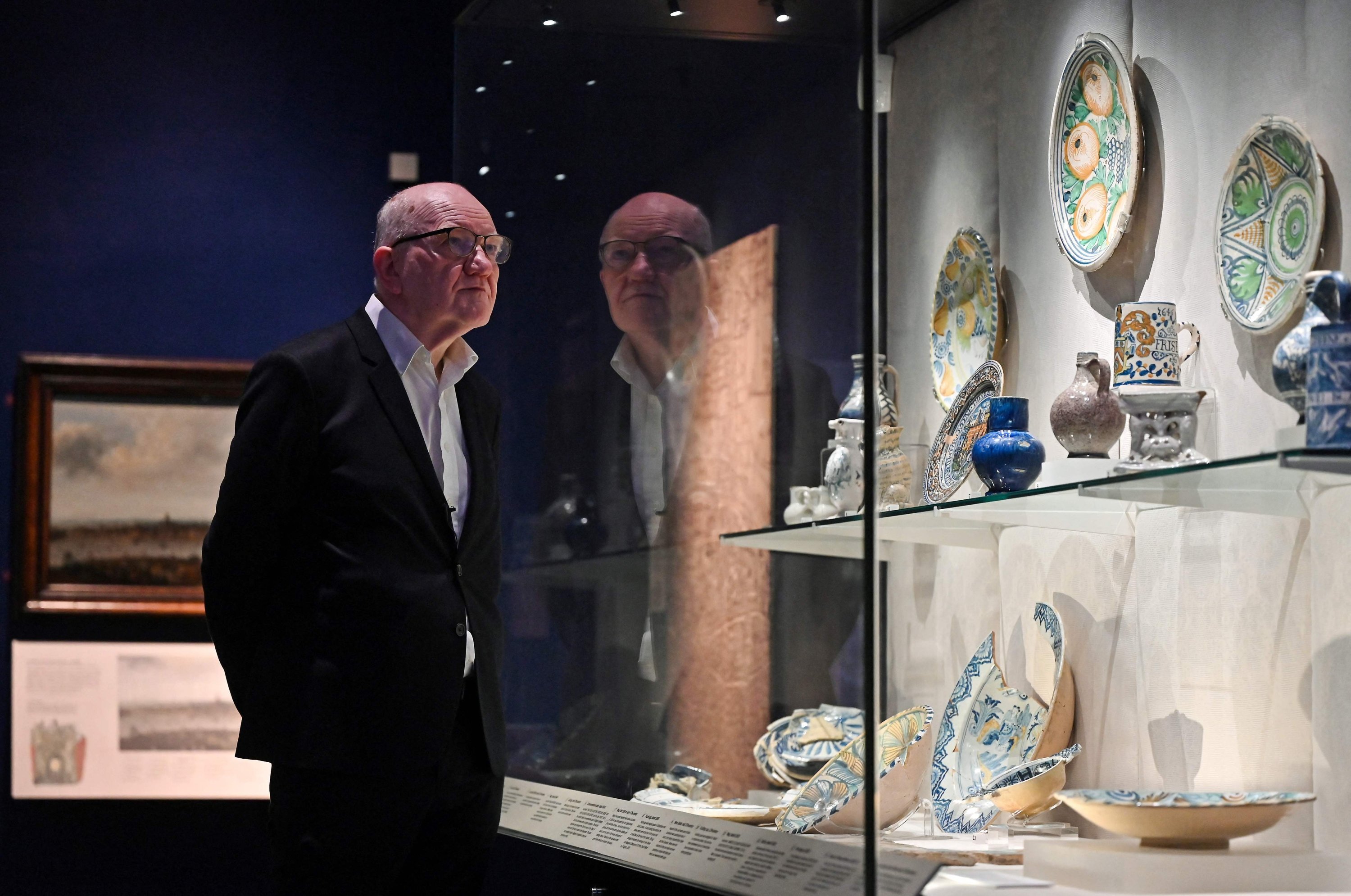 The London museum Director of Content Finbarr Whooley looks at a glass case displaying a set of ceramics objects at the Museum of London, London, U.K., Nov. 8, 2022. (AFP Photo)