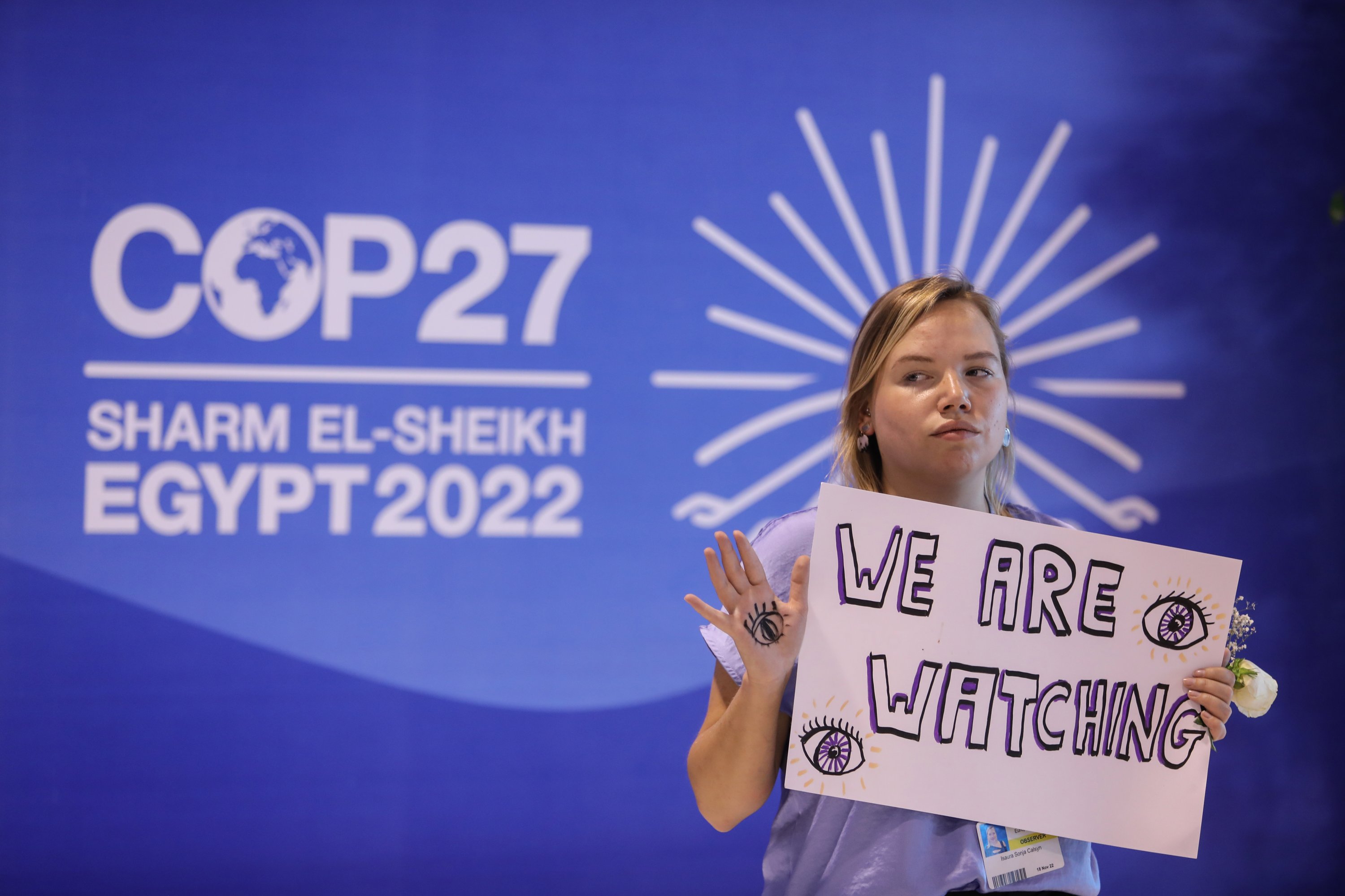 An activist holds a sign at the COP27 summit in Sharm El-Sheikh, Egypt, Nov. 19, 2022. (AA Photo)