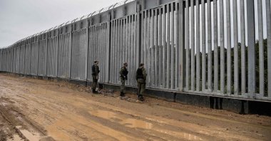 Police officers patrol along a steel fence along Evros River, Greece&#039;s river border with Türkiye, June 8, 2021. (AFP Photo)