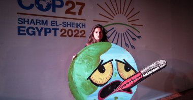 An activist holds a sign at the COP27 summit in Sharm El-Sheikh, Egypt, Nov. 19, 2022. (EPA Photo)