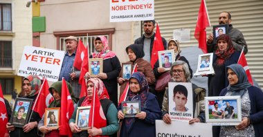 Families hold photos of their children and placards with slogans calling for their return, in Diyarbakır, southeastern Türkiye, Nov. 20. 2022. (AA Photo) 