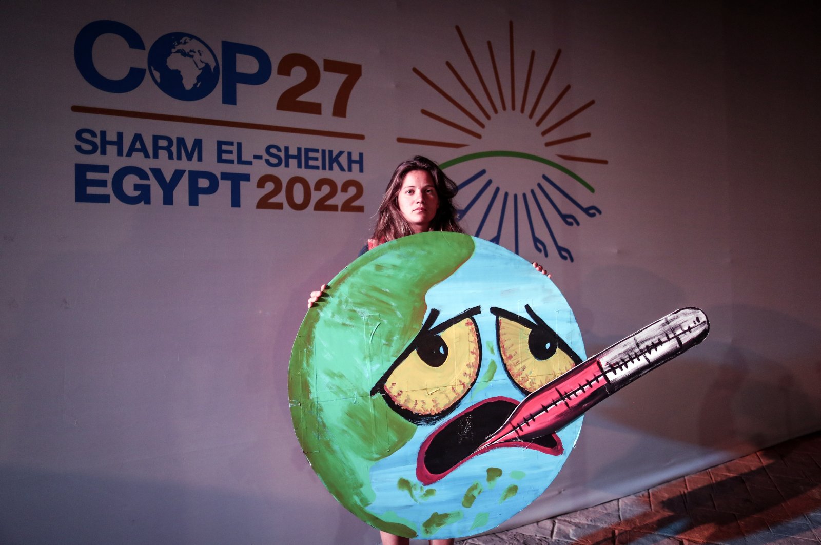 An activist holds a sign at the COP27 summit in Sharm El-Sheikh, Egypt, Nov. 19, 2022. (EPA Photo)