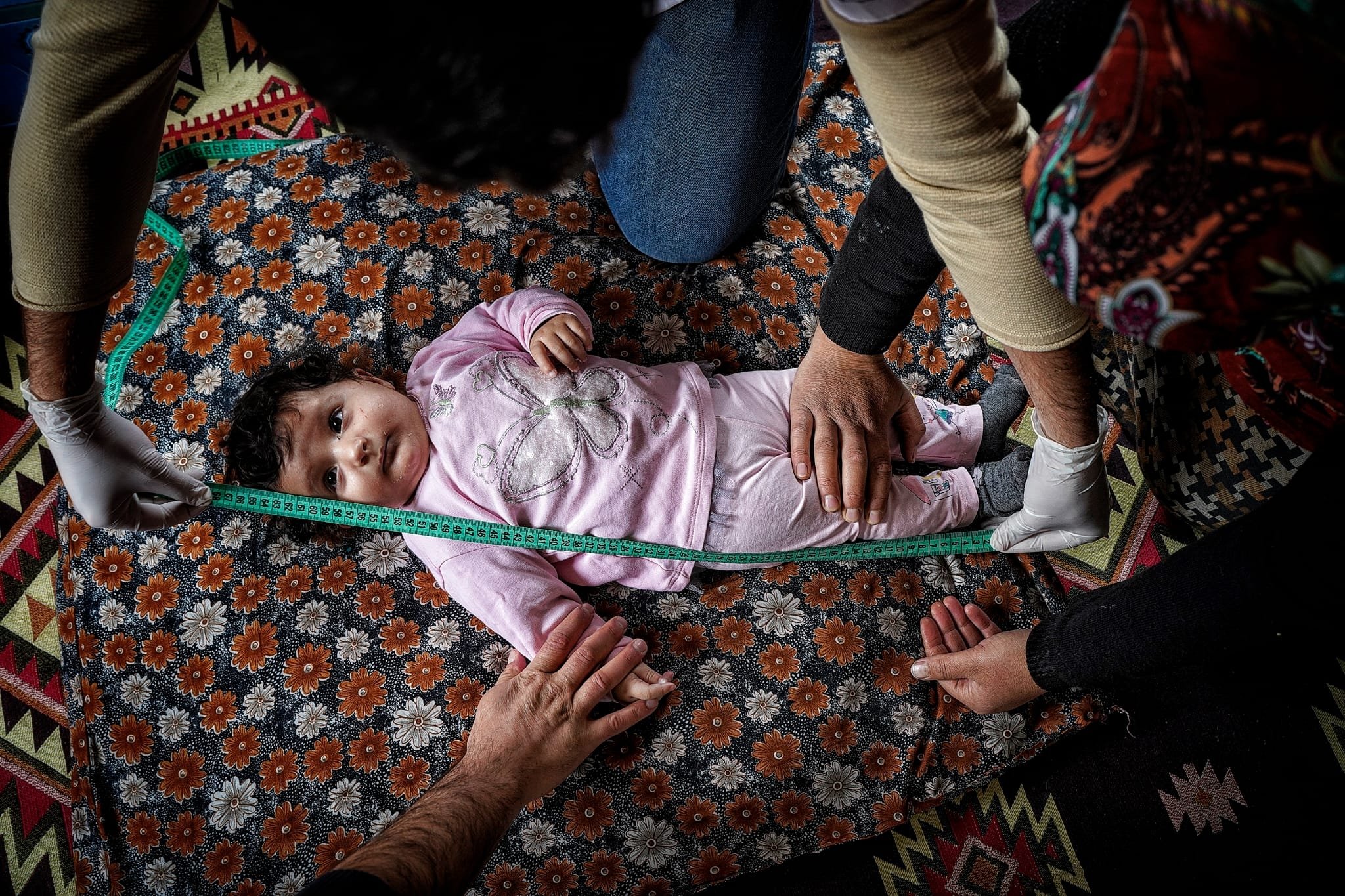 Health care workers measure the height of an infant in a village, in Bitlis, eastern Türkiye, Nov. 20, 2022. (Photo by Uğur Yıldrım)