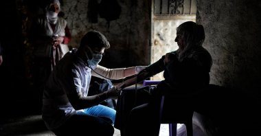 A doctor checks the blood pressure of a woman in a village, in Bitlis, eastern Türkiye, Nov. 20, 2022. (Photo by Uğur Yıldrım)