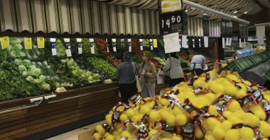 People buy local products at a food market in Ankara, Türkiye, May 8, 2022. (AP Photo)
