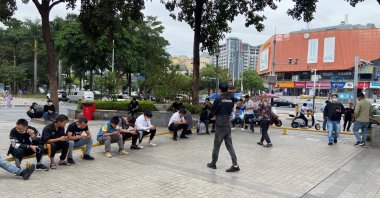 People sit by Shenzhen's main factory recruitment hub in Longhua district, Guangdong province, China, Nov., 1, 2022. (Reuters Photo)
