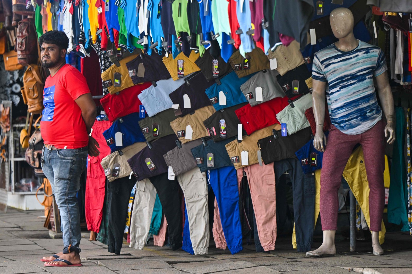 A vendor selling clothes waits for customers at a roadside stall in Colombo, Sri Lanka, Nov., 15, 2022. (AFP Photo)