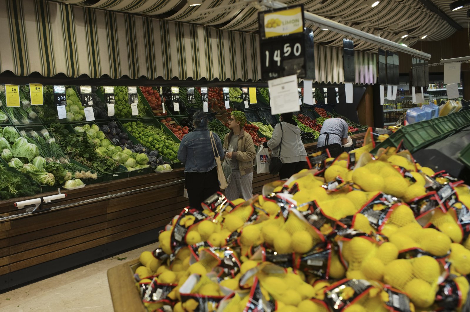 People buy local products at a food market in Ankara, Türkiye, May 8, 2022. (AP Photo)