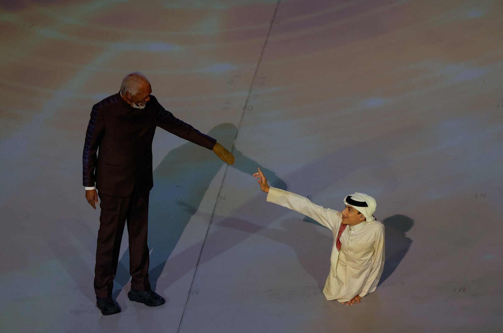 U.S. actor Morgan Freeman (L) and Qatar&#039;s FIFA Ambassador Ghanim Al Muftah attend the opening ceremony ahead of the Qatar 2022 World Cup Group A football match between Qatar and Ecuador at the Al-Bayt Stadium, Al Khor, Doha, Qatar, Nov. 20, 2022. (AFP Photo)