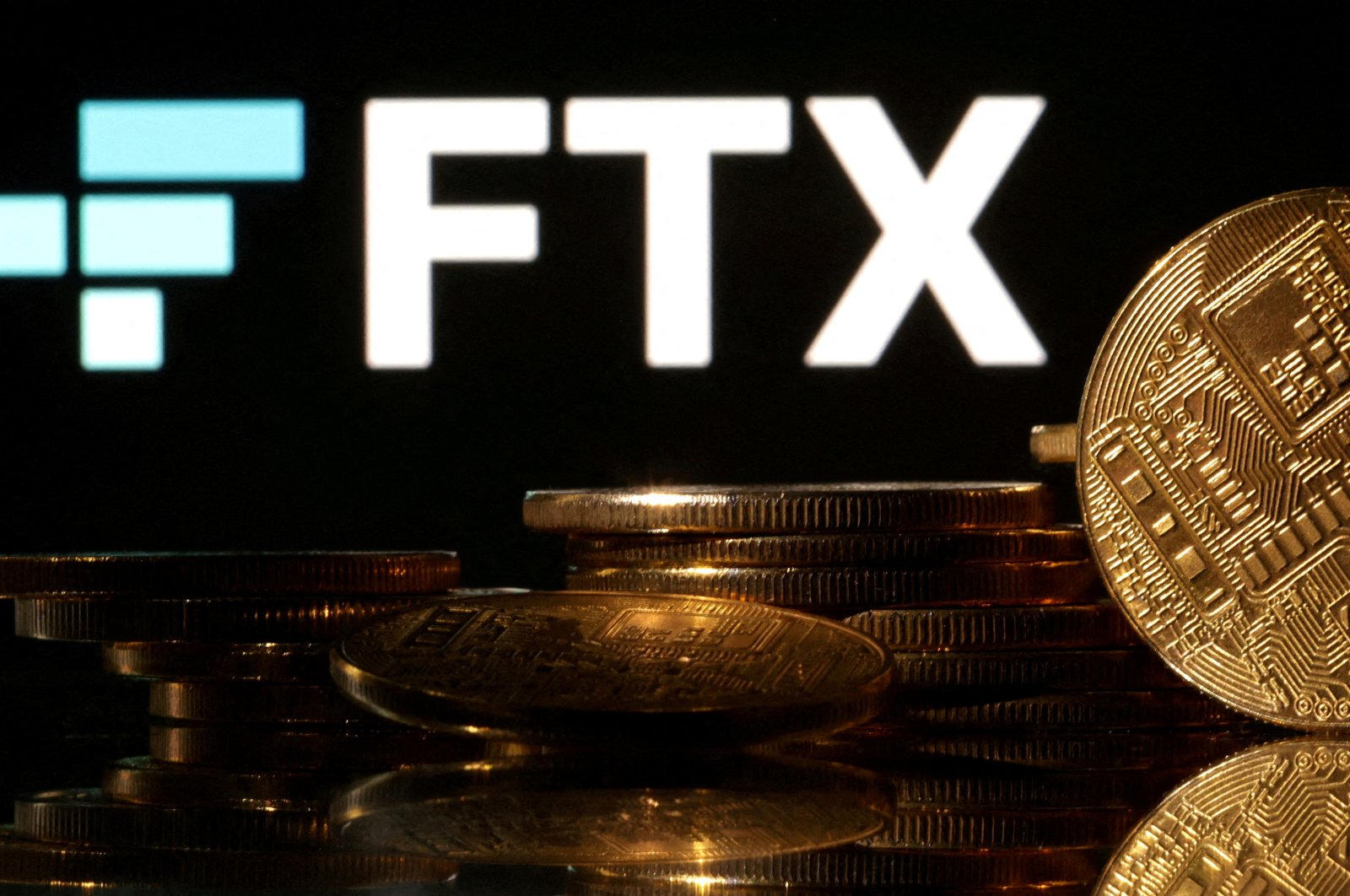 Representations of cryptocurrencies are seen in front of displayed FTX logo in this illustration taken Nov. 10, 2022. (Reuters Photo)