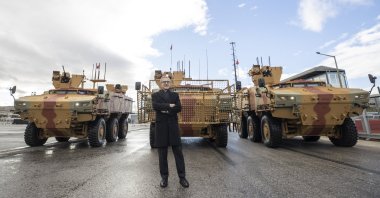 SSB Head Ismail Demir poses in front of the PARS 6x6 vehicles at the FNSS facility in Gölbaşı, Ankara, Türkiye, Nov. 22, 2022. (AA Photo)