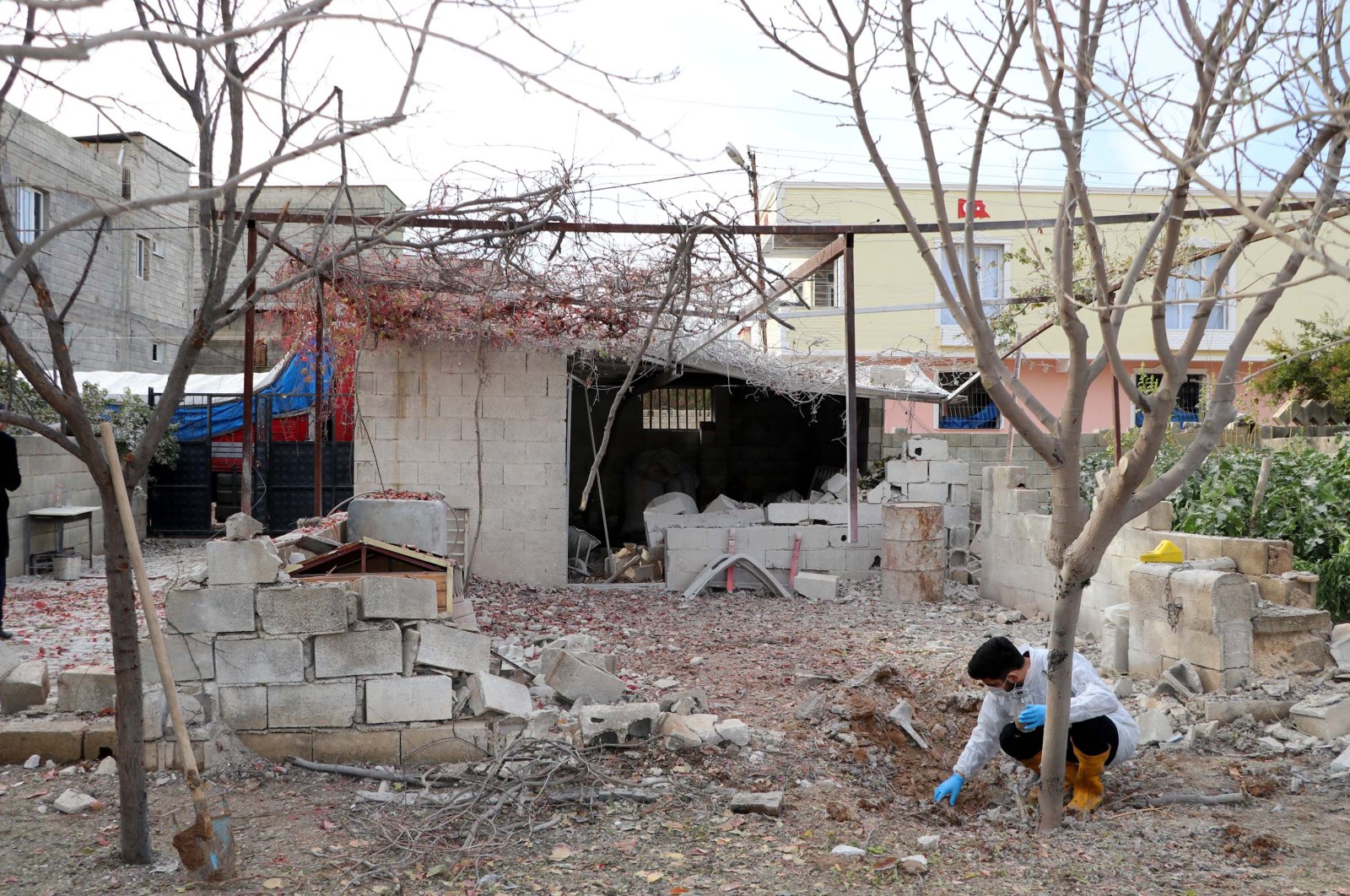 An official is seen digging through the rubble of a home following a rocket attack by the PKK/YPG terrorist group in Türkiye&#039;s southeastern province of Gaziantep, Nov. 21, 2022. (DHA Photo)