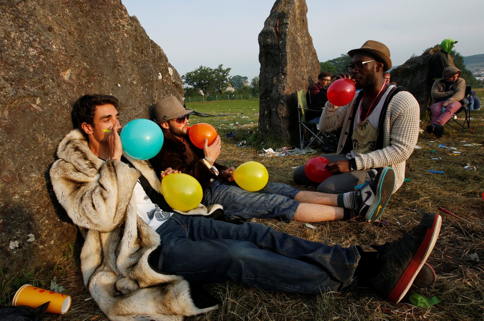 Festival goers inhale laughing gas at sunrise at the stone circle on the second day of the Glastonbury music festival at Worthy Farm in Somerset, U.K., June 27, 2013. (Reuters Photo)