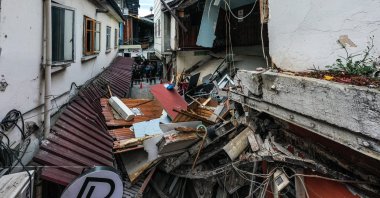Pieces of damaged houses litter a narrow street, in Düzce, northern Türkiye, Nov. 23, 2022. (AA Photo)