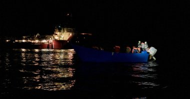 Migrants prepare to get on board the Ocean Viking ship sailing in the international waters off Malta in the Mediterranean Sea, after being rescued by the European maritime-humanitarian organization &quot;SOS Mediterranee&quot; overnight, Oct. 25, 2022. (AFP Photo)
