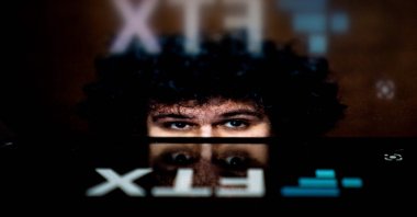 This photo illustration shows the logo of cryptocurrency FTX, reflected in an image of former chief executive Samuel Bankman-Fried, in Washington, DC, U.S., Nov. 13, 2022. (AFP Photo)