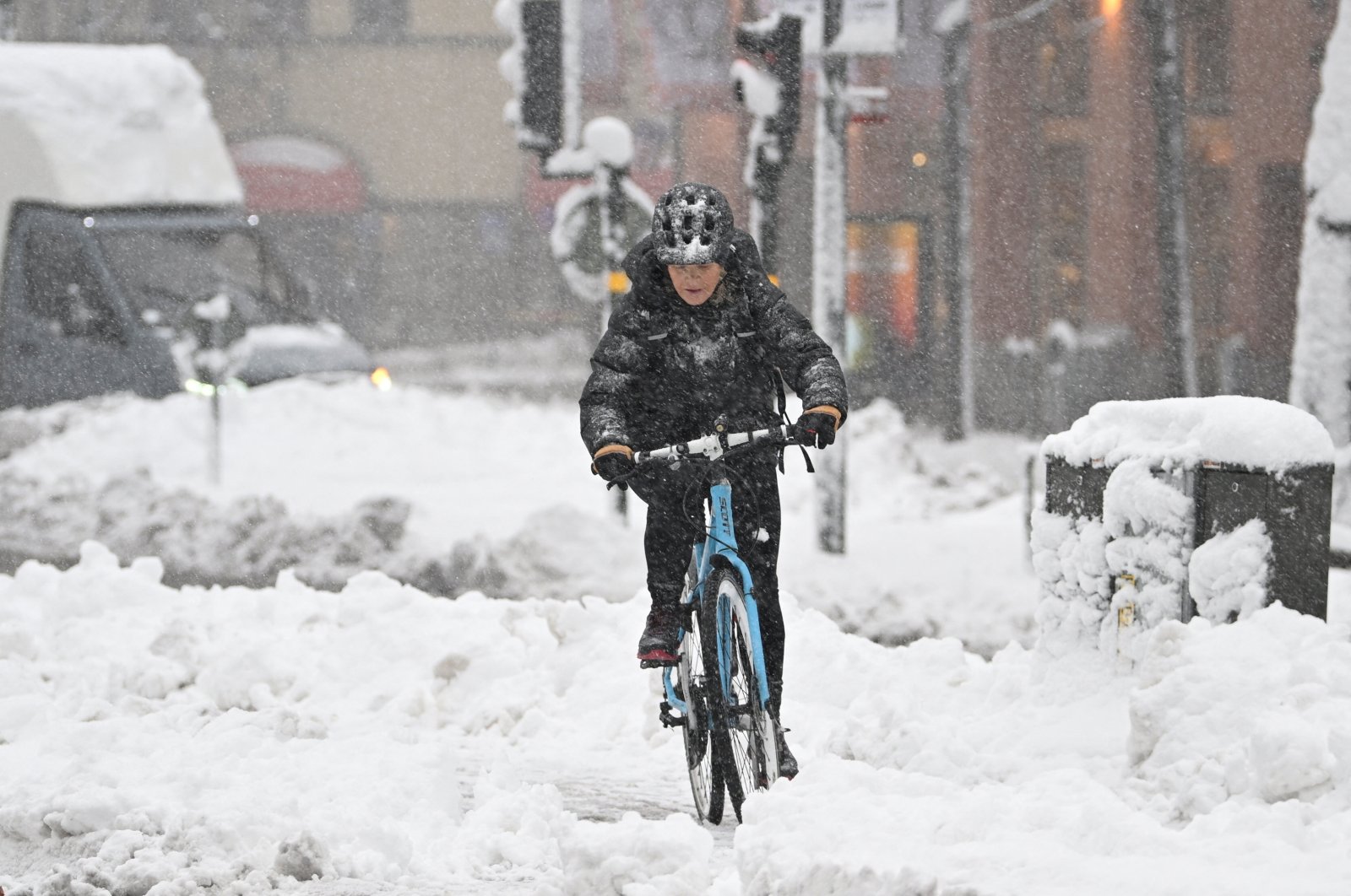 A woman rides a bicycle amid heavy snowfall in central Stockholm, Sweden, Nov. 21, 2022. (Reuters Photo)