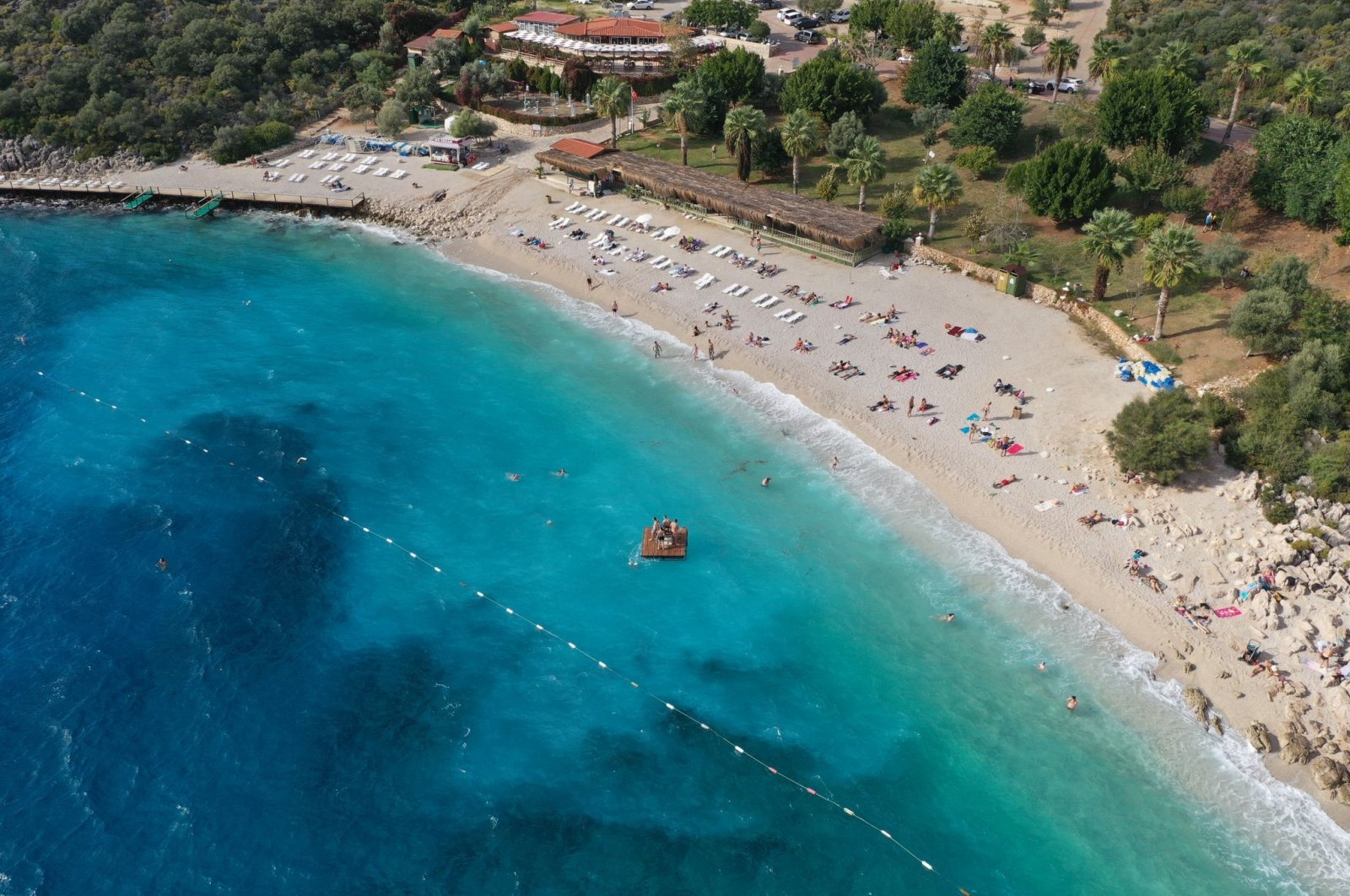 Aerial photo of tourists taking advantage of the sunny weather on the beach in Antalya&#039;s Kaş district, Türkiye, Nov. 19, 2022. (AA Photo)