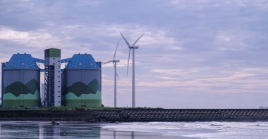A plane flies over wind turbines in Taipei, Taiwan, July 24, 2021. (Reuters Photo)
