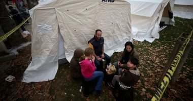 A family having breakfast outside their tent, in Düzce, northern Türkiye, Nov. 24, 2022. (AA Photo) 