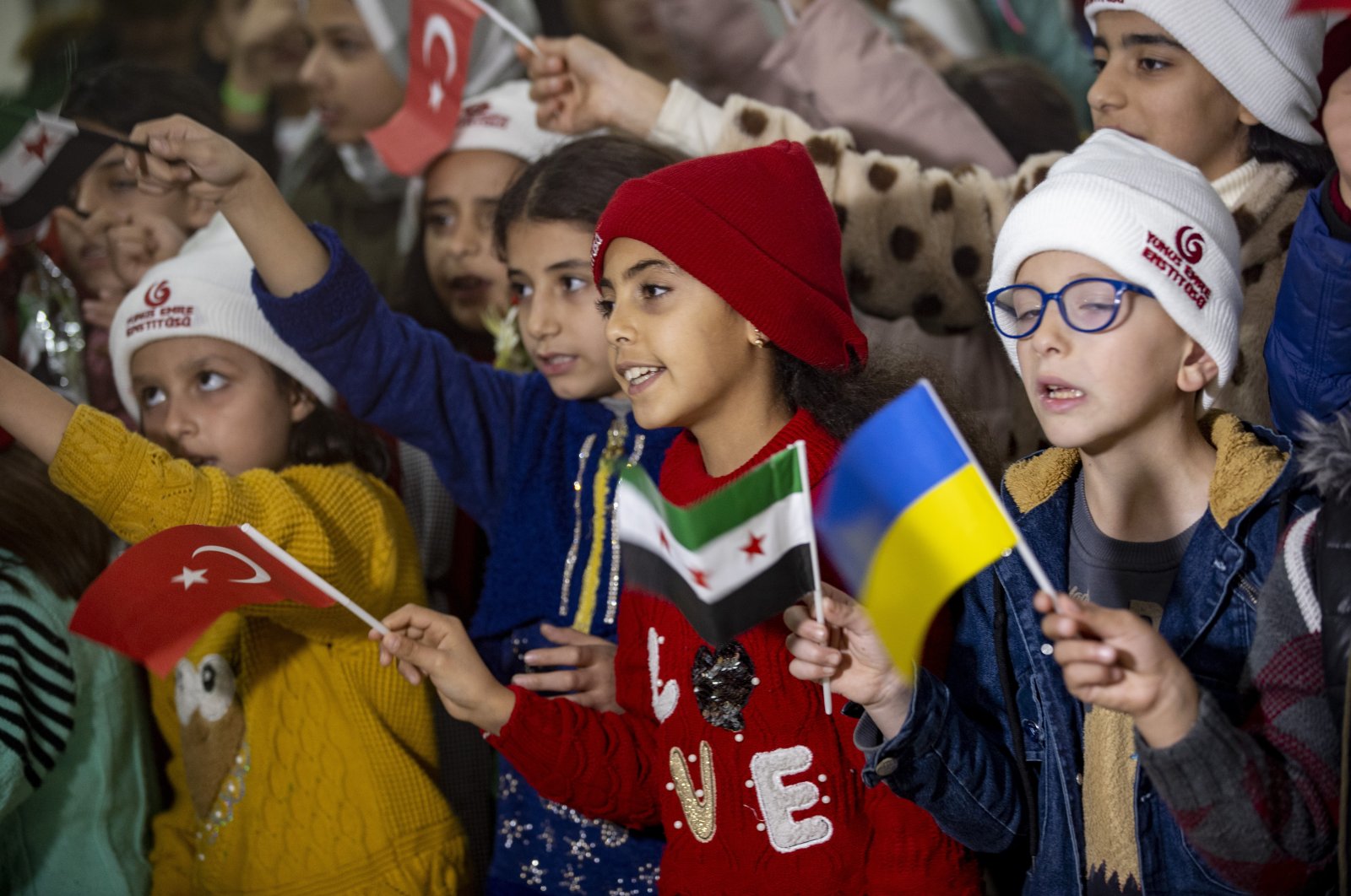 Syrian and Ukrainian children wave flags during the event, in Antalya, southern Türkiye, Nov. 24, 2022. (AA Photo)