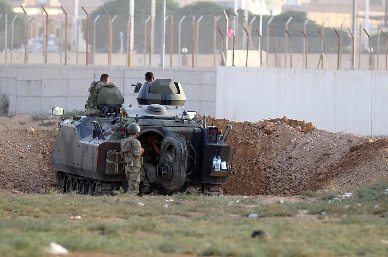 In this file photo taken, a Turkish army armored personnel carrier is dug in on the border with Syria near Akçakale, October 7, 2012. (AFP Photo)