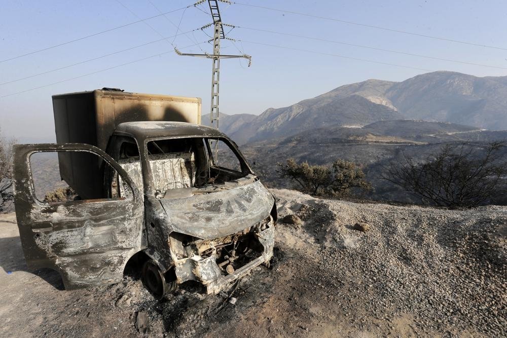 A charred truck is pictured after a fire near the village of Achlouf, the Kabyle region, Algiers, Aug. 13, 2021. (AP Photo)