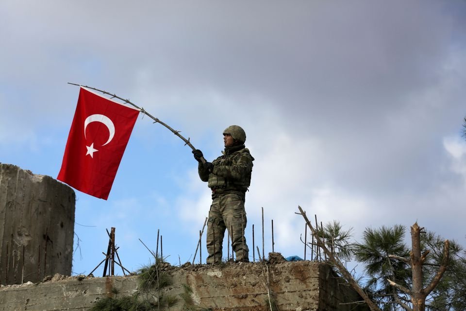 A Turkish soldier waves a flag on Mount Barsaya, northeast of Afrin, Syria, Jan. 28, 2018. (Reuters File Photo)