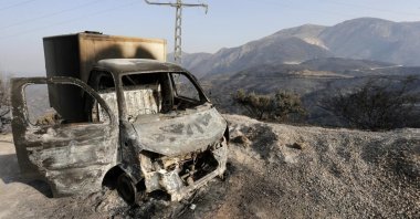 A charred truck is pictured after a fire near the village of Achlouf, the Kabyle region, Algiers, Aug. 13, 2021. (AP Photo)