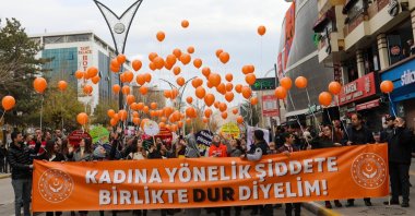 Women carry a banner with a slogan against violence targeting women and release orange balloons symbolizing the day, in Van, eastern Türkiye, Nov. 25, 2022. (İHA Photo) 