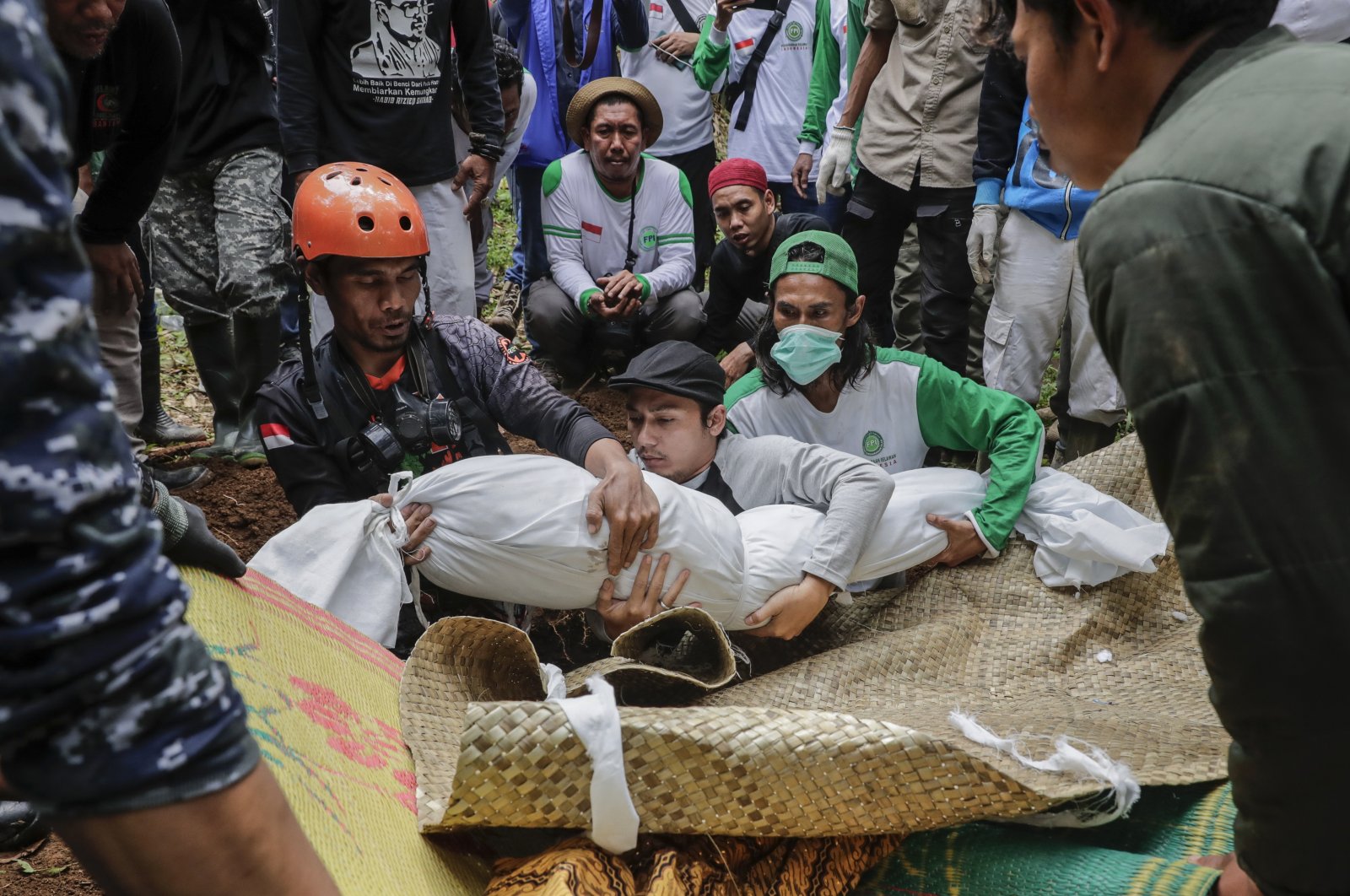 Rescuers and villagers carry the body of a victim during a funeral at a village affected by the 5.6 magnitude earthquake, Cianjur, West Java, Indonesia, Nov. 25, 2022. (EPA Photo)