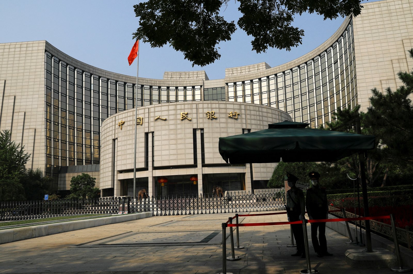 Paramilitary police officers stand guard in front of the headquarters of the People&#039;s Bank of China, the central bank (PBOC), in Beijing, China, Sept. 30, 2022. (Reuters Photo)