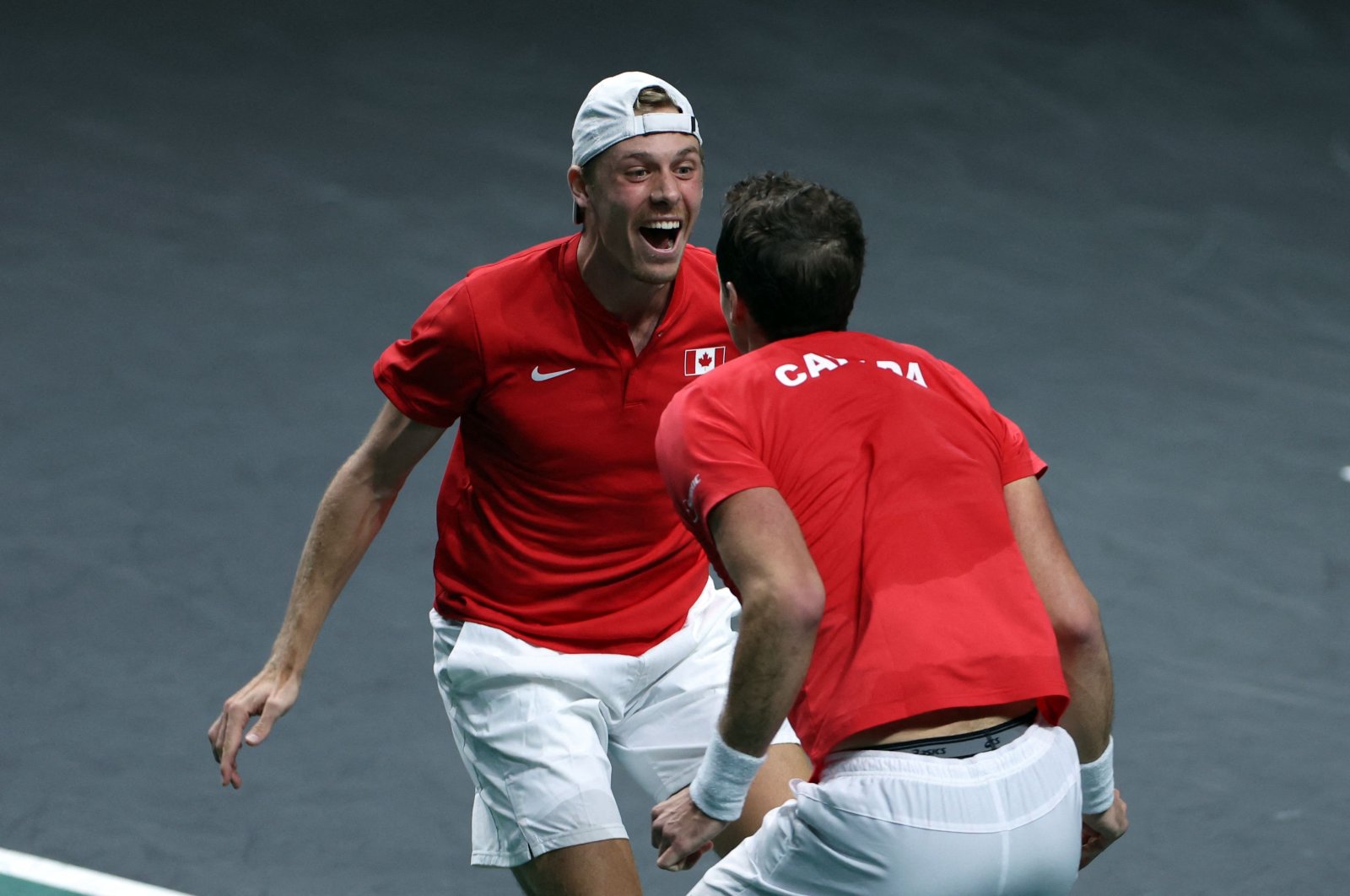 Canada&#039;s Denis Shapovalov and Vasek Pospisil celebrate after winning the men&#039;s double quarterfinal tennis match between Germany and Canada of the Davis Cup tennis tournament at the Martin Carpena sports hall, Malaga, Spain, Nov. 24, 2022. (AFP Photo)