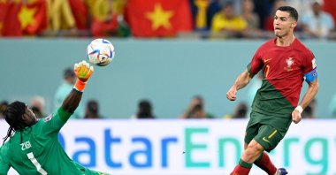 Ghana's goalkeeper Lawrence Ati Zigi saves a shot at the goal by Portugal's forward Cristiano Ronaldo (R) during the Qatar 2022 World Cup Group H football match between Portugal and Ghana at Stadium 974, Doha, Qatar, Nov. 24, 2022. (AFP Photo)