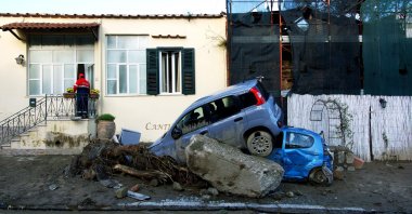 A rescuer checks a damaged house in Casamicciola, Italy, Nov. 27, 2022. (AFP Photo)