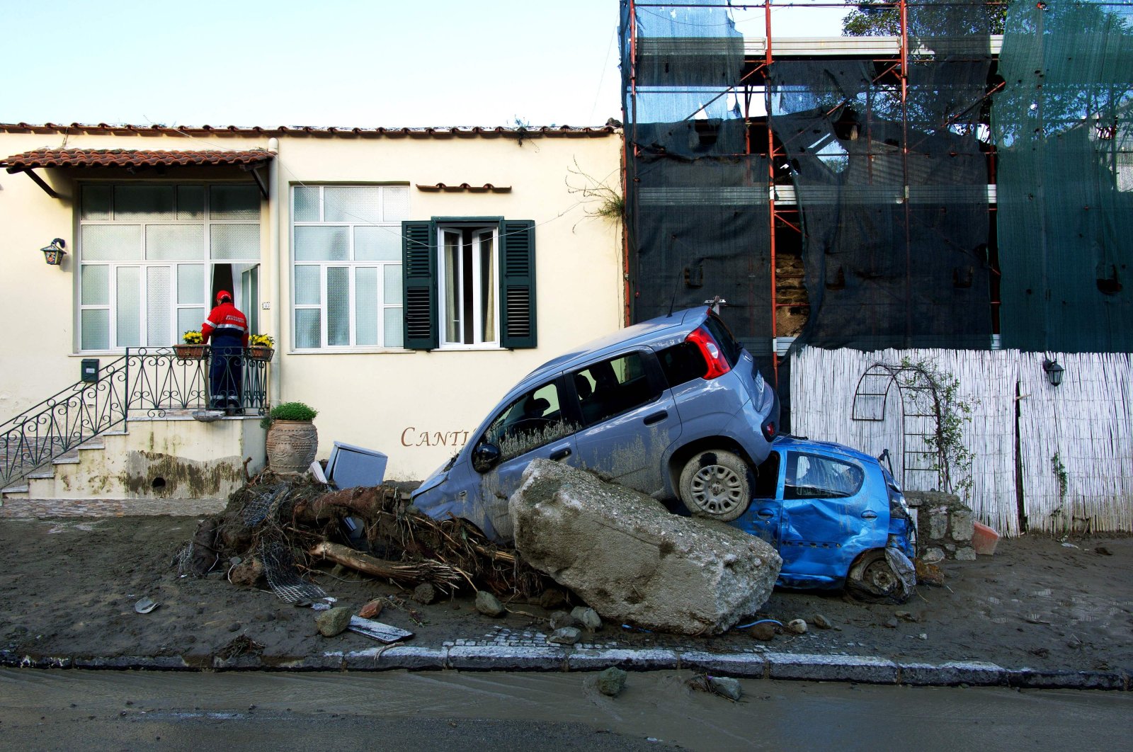 A rescuer checks a damaged house in Casamicciola, Italy, Nov. 27, 2022. (AFP Photo)