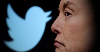 Twitter logo and a photo of Elon Musk are displayed through a magnifier in this illustration taken Oct. 27, 2022. (Reuters File Photo)