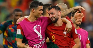 Portugal's forward #07 Cristiano Ronaldo (L) and Portugal's midfielder #08 Bruno Fernandes celebrate after they won the Qatar 2022 World Cup Group H football match between Portugal and Uruguay at the Lusail Stadium in Lusail, north of Doha on Nov. 28, 2022. (AFP Photo)