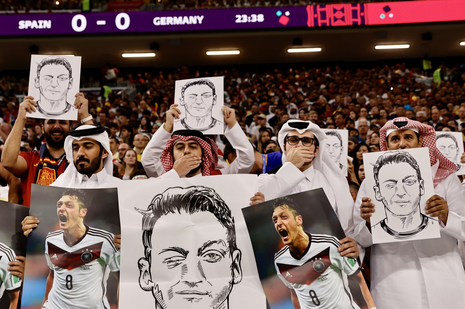 Fans hold up signs displaying former Germany player Mesut Ozil in the stands at the Al Bayt Stadium, Al Khor, Qatar, Nov. 27, 2022. (Reuters Photo)