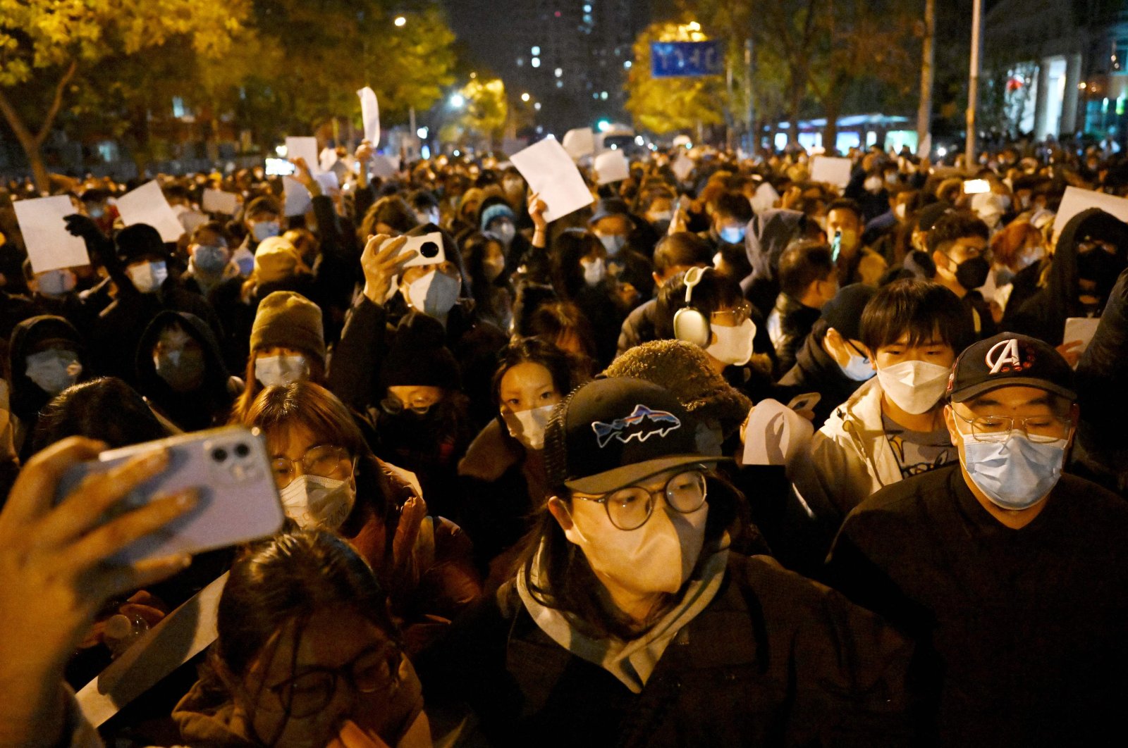 Protesters march along a street during a rally for the victims of a deadly fire as well as a protest against China&#039;s harsh COVID-19 restrictions, Beijing, China, Nov. 28, 2022.
