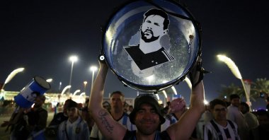 An Argentina fan holds up his drum with an image of Lionel Messi on it during the World Cup, Doha, Qatar, Nov. 25, 2022. (Reuters Photo)
