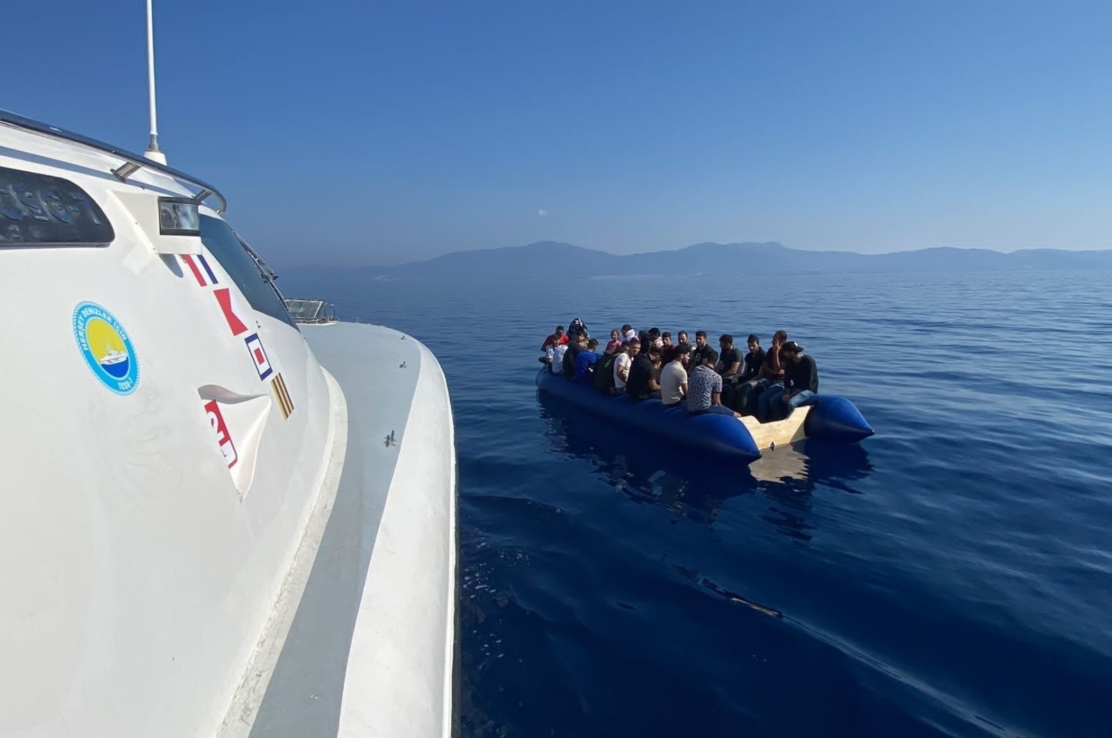 A Turkish coast guard boat approaches a migrant boat, in Izmir, western Türkiye, Sept. 6, 2022. (AA Photo)