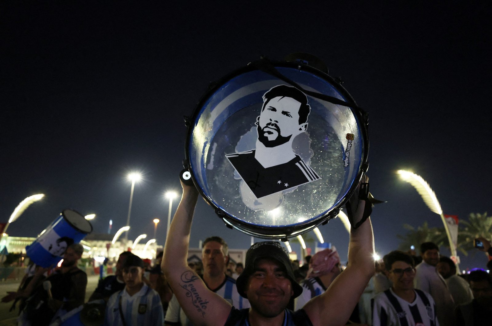 An Argentina fan holds up his drum with an image of Lionel Messi on it during the World Cup, Doha, Qatar, Nov. 25, 2022. (Reuters Photo)